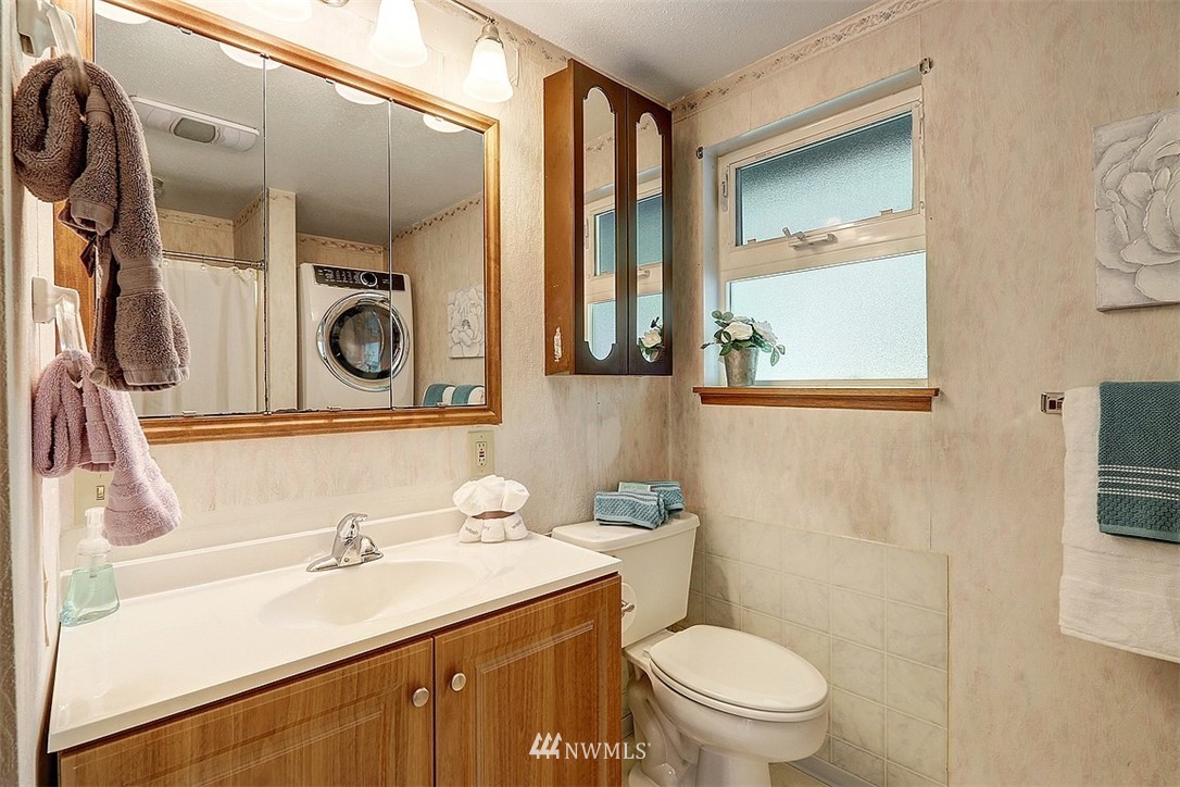 24217 4th Place West Bothell, WA 98021 - Photo 10 of 19 a bathroom with a sink a toilet and a mirror