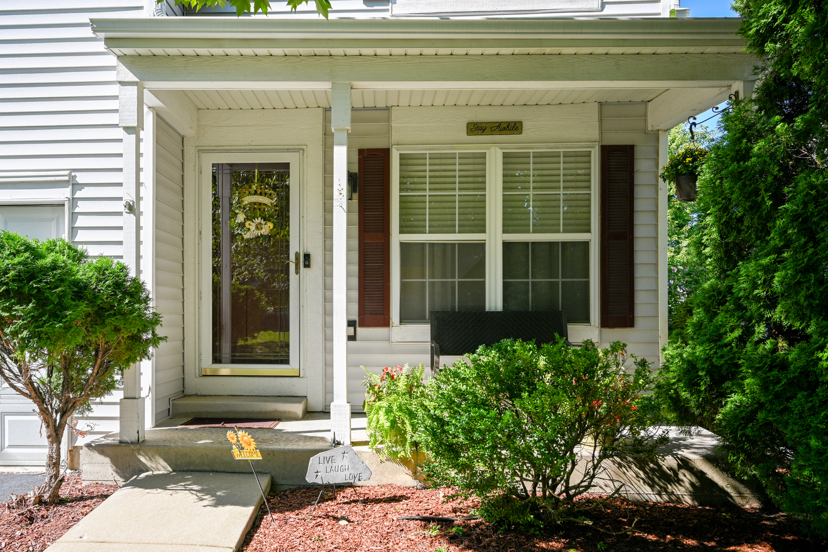 5805 Emerald Pointe Drive Plainfield, IL 60586 - Photo 2 of 25 a front view of a house with a large window and potted plants