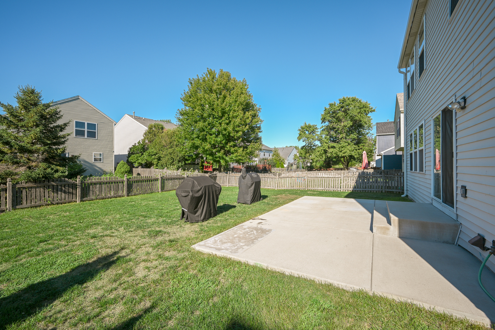 5805 Emerald Pointe Drive Plainfield, IL 60586 - Photo 24 of 25 a view of a backyard with sitting area