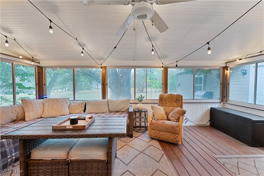 6370 Fairview Road Youngstown, OH 44515 - Photo 15 of 38 Sunroom with rail lighting, an outdoor hangout area, healthy amount of natural light, and hardwood / wood-style flooring