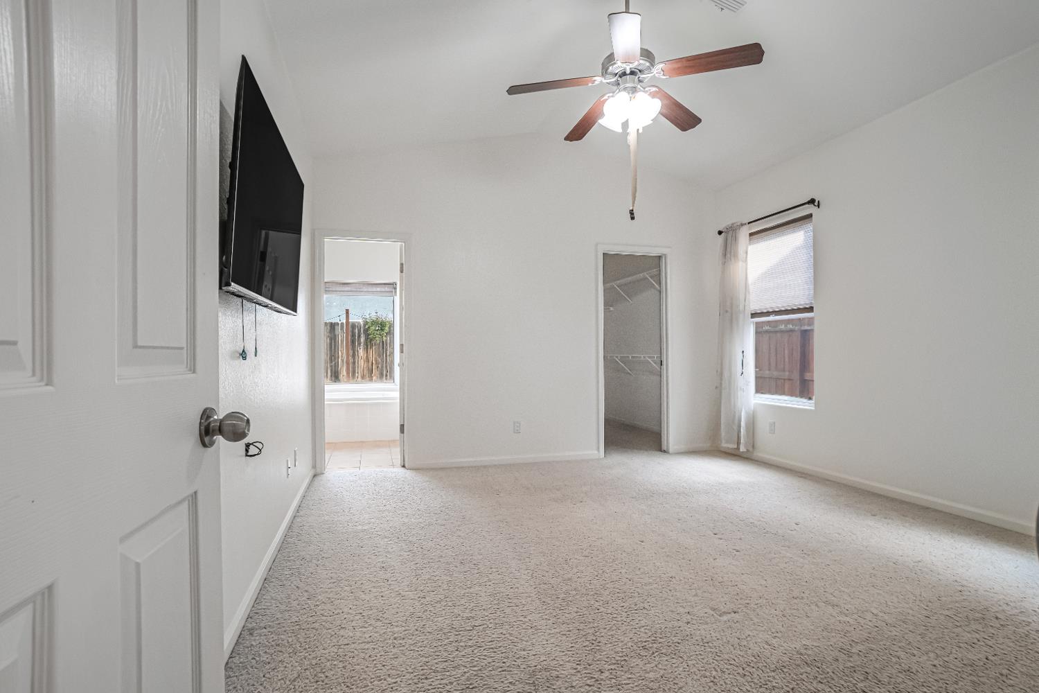 3062 North Filbert Avenue Fresno, CA 93727 - Photo 15 of 41 a view of a hallway with a chandelier fan