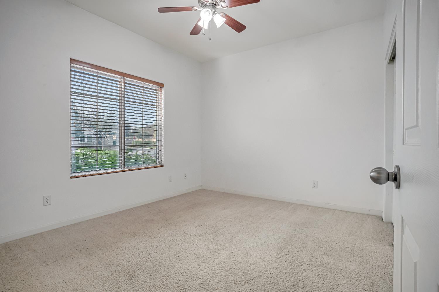 3062 North Filbert Avenue Fresno, CA 93727 - Photo 20 of 41 an empty room with a window and a ceiling fan