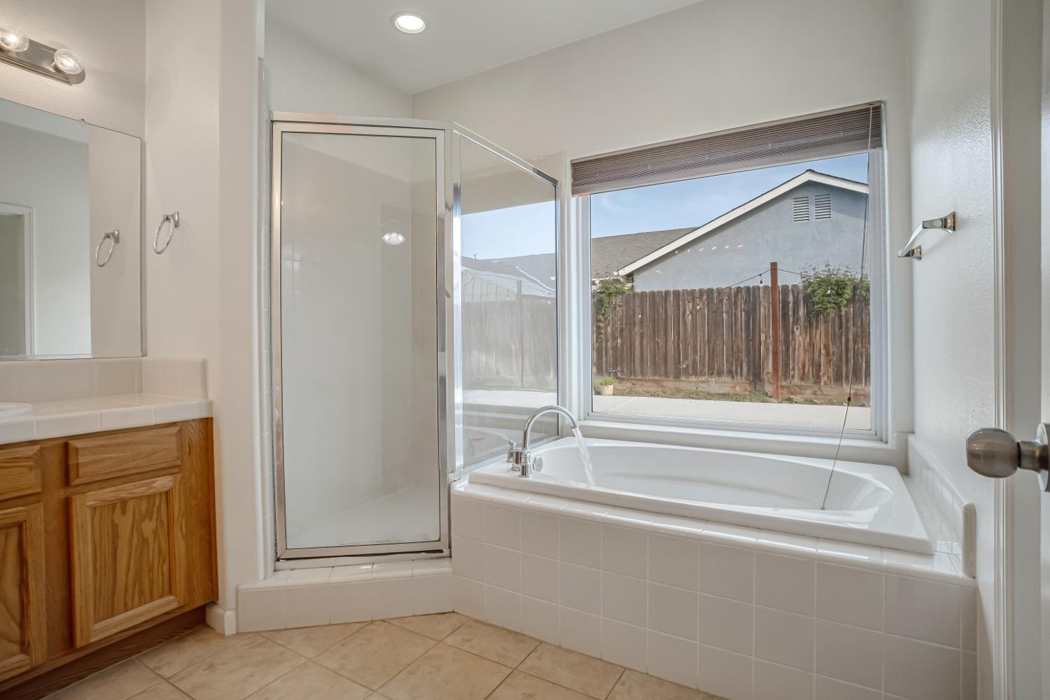 3062 North Filbert Avenue Fresno, CA 93727 - Photo 21 of 41 a bathroom with a bathtub and a shower