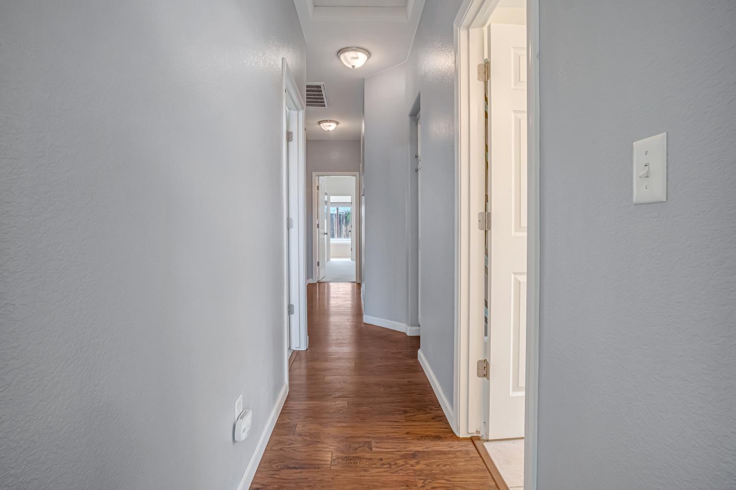 3062 North Filbert Avenue Fresno, CA 93727 - Photo 27 of 41 a view of a hallway with wooden floor