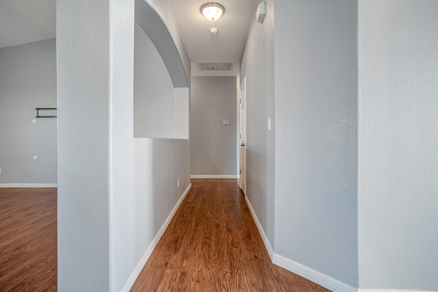 3062 North Filbert Avenue Fresno, CA 93727 - Photo 29 of 41 a view of a hallway with wooden floor and staircase
