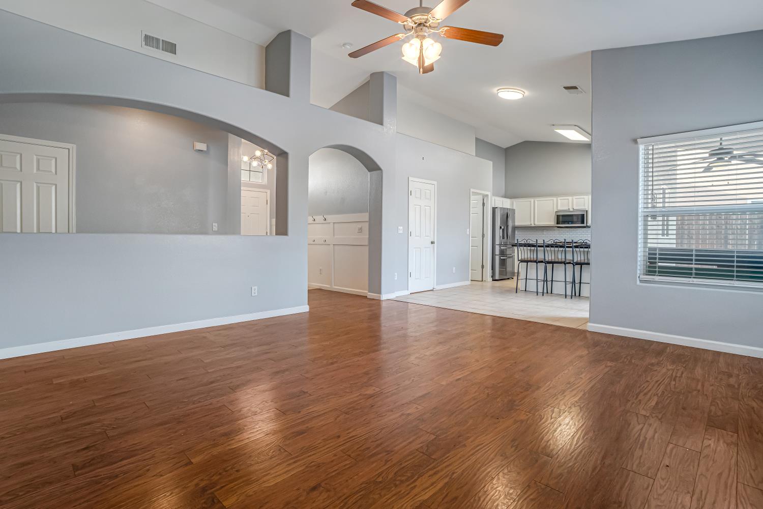 3062 North Filbert Avenue Fresno, CA 93727 - Photo 3 of 41 an empty room with wooden floor fan and windows