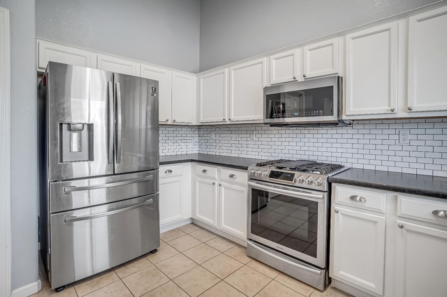 3062 North Filbert Avenue Fresno, CA 93727 - Photo 8 of 41 a kitchen with cabinets stainless steel appliances and cabinets
