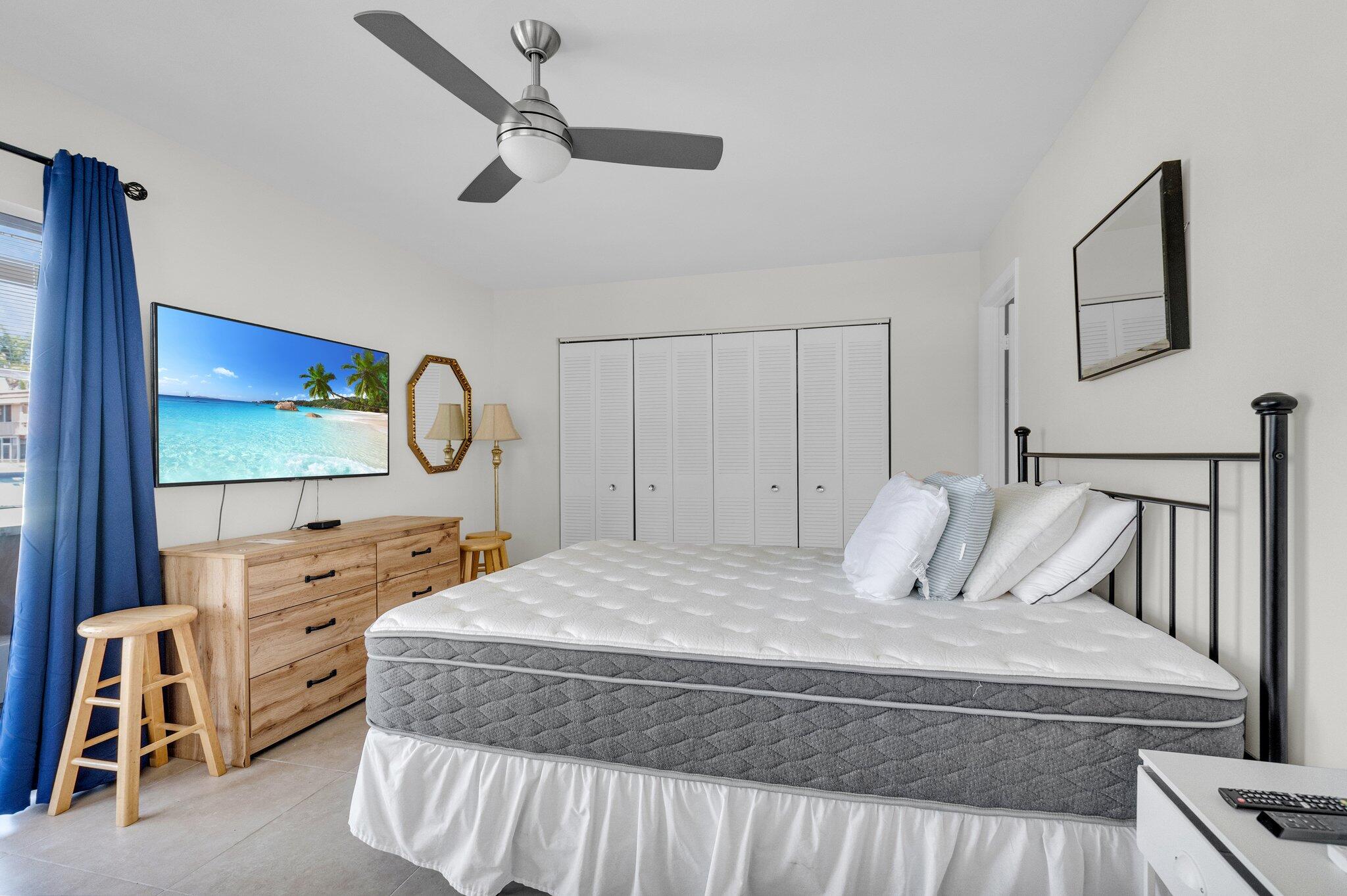 392 Monaco Way, Unit 392 Delray Beach, FL 33446 - Photo 20 of 47 a bedroom with a bed and a large mirror