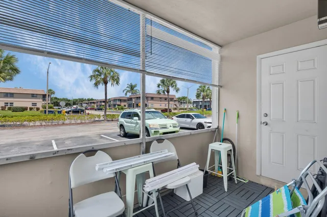 a dining room with furniture and a floor to ceiling window