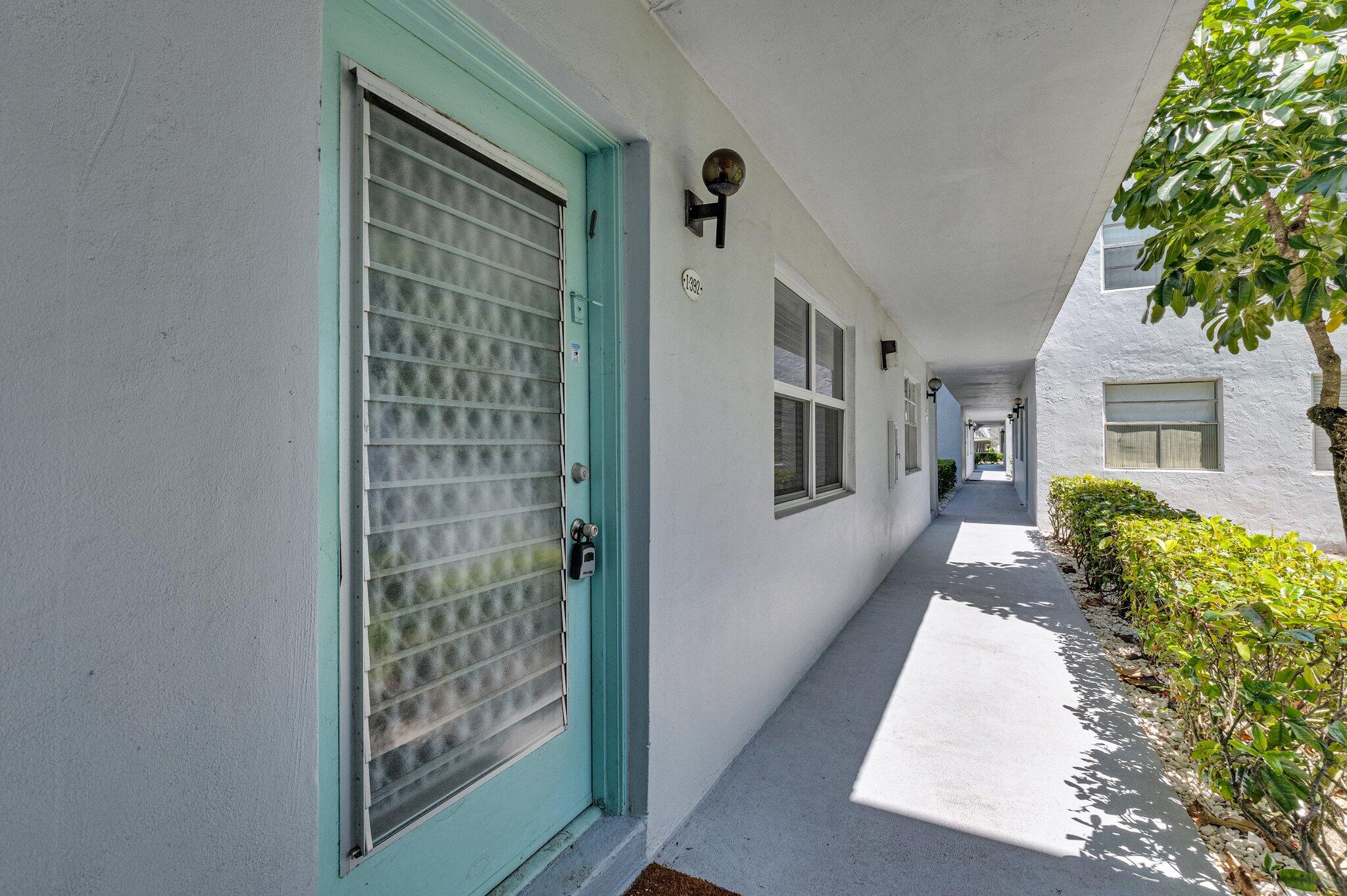 392 Monaco Way, Unit 392 Delray Beach, FL 33446 - Photo 5 of 47 a front view of a house with a yard