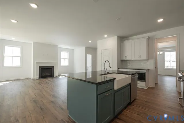 a view of an empty room with a fireplace and a window
