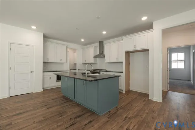 an empty room with wooden floor fireplace and windows