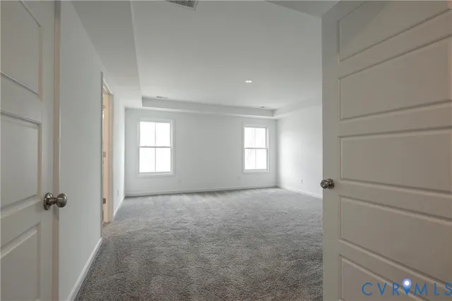 a view of a room with wooden floor and a window