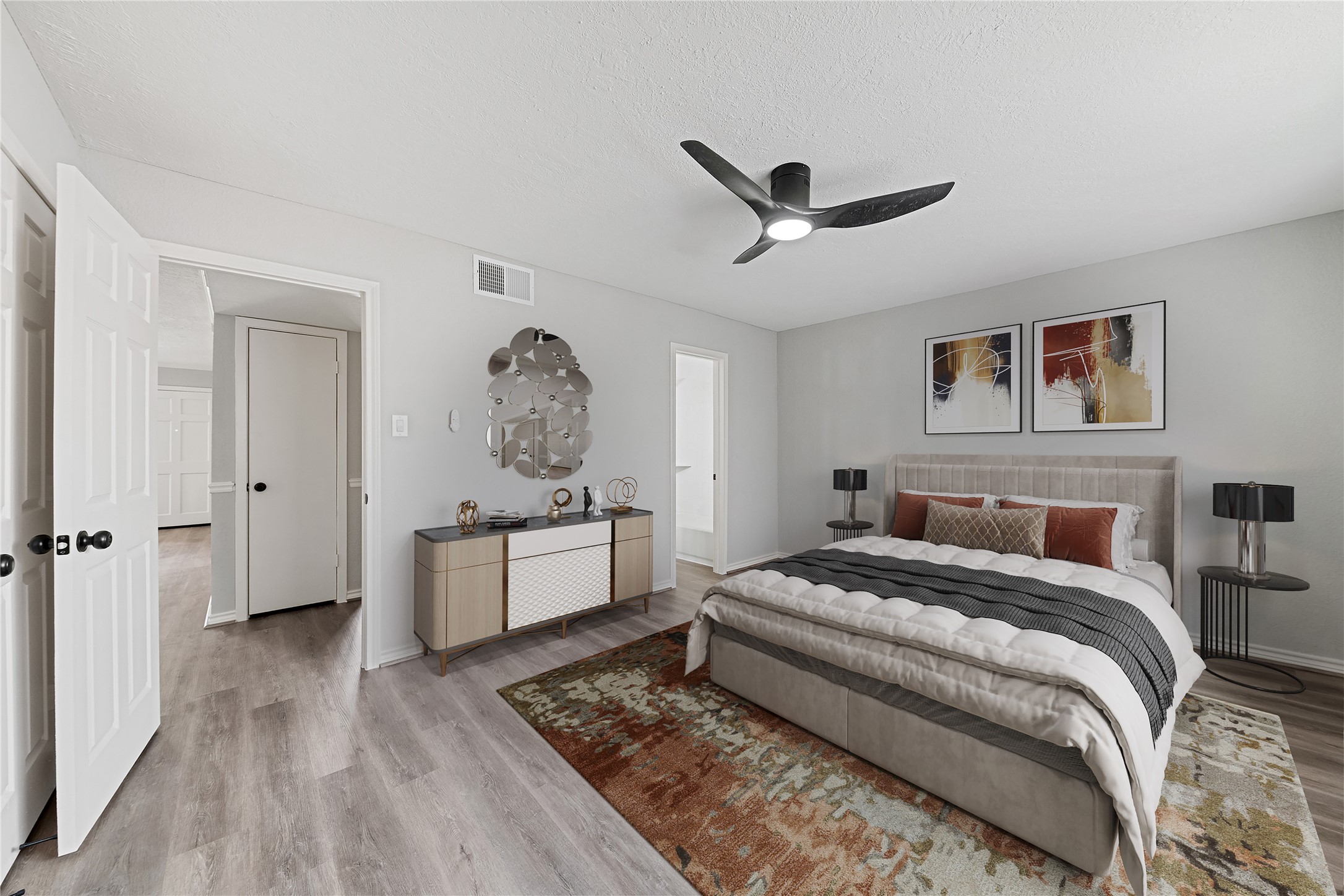 2675 Gessner Road Houston, TX 77080 - Photo 19 of 40 a bedroom with a large bed and a chandelier