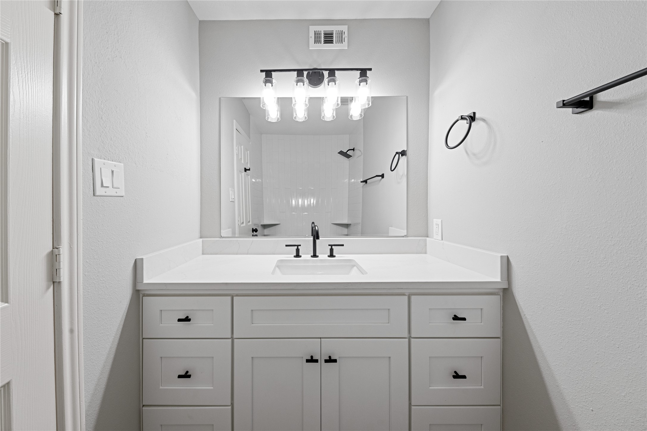 2675 Gessner Road Houston, TX 77080 - Photo 23 of 40 a bathroom with a sink vanity and mirror