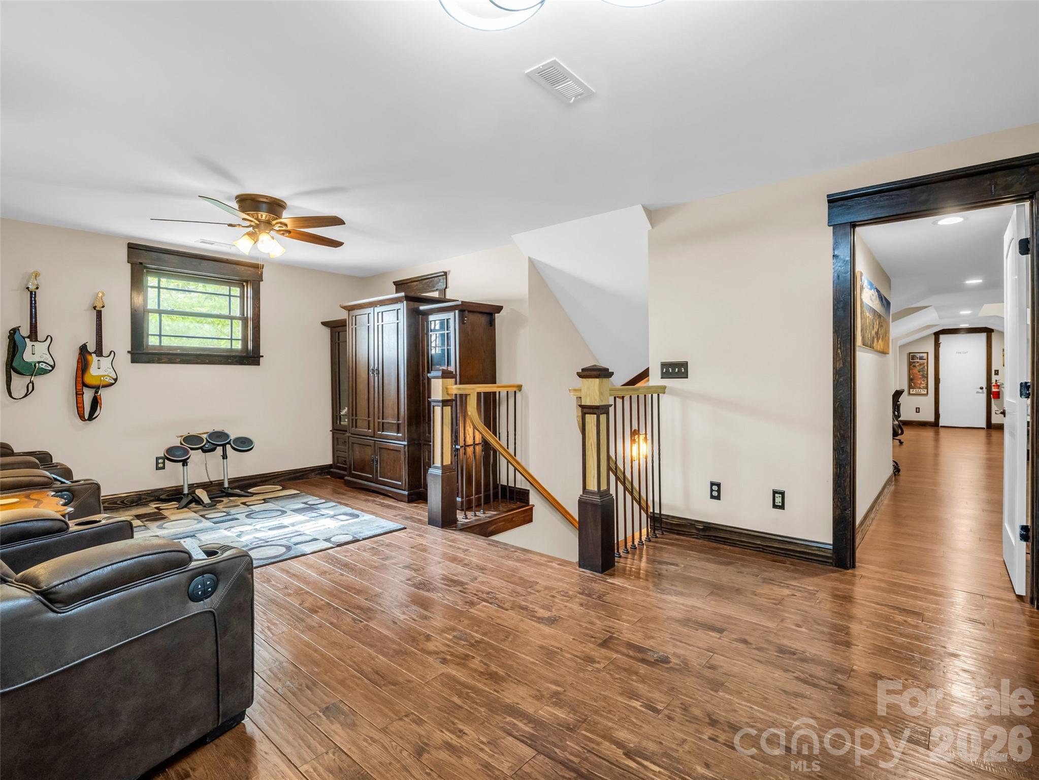 174 Rock Ridge Lake Lure, NC 28746 - Photo 24 of 48 a view of a livingroom with wooden floor and a ceiling fan