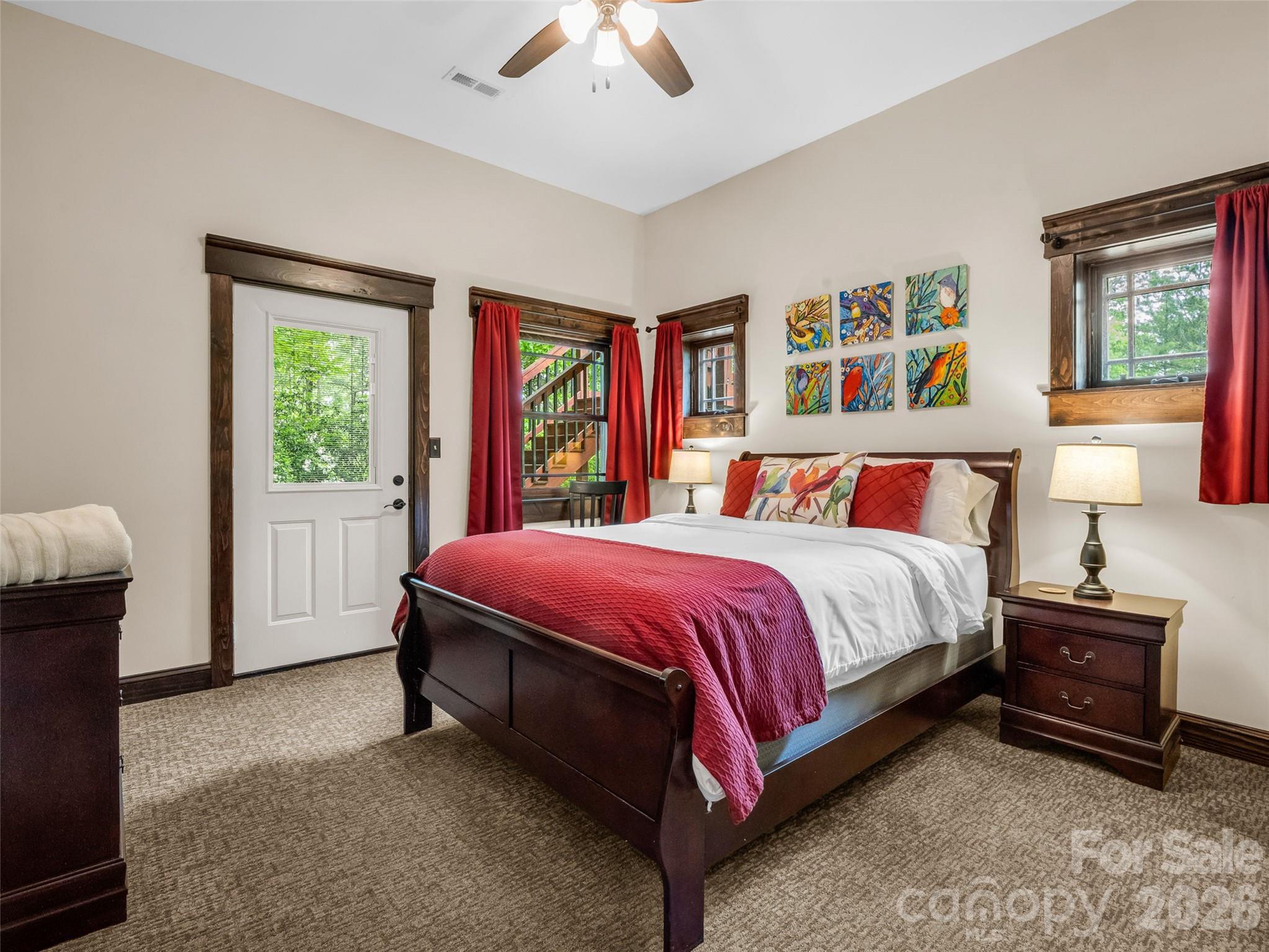 174 Rock Ridge Lake Lure, NC 28746 - Photo 33 of 48 a spacious bedroom with a bed and a window