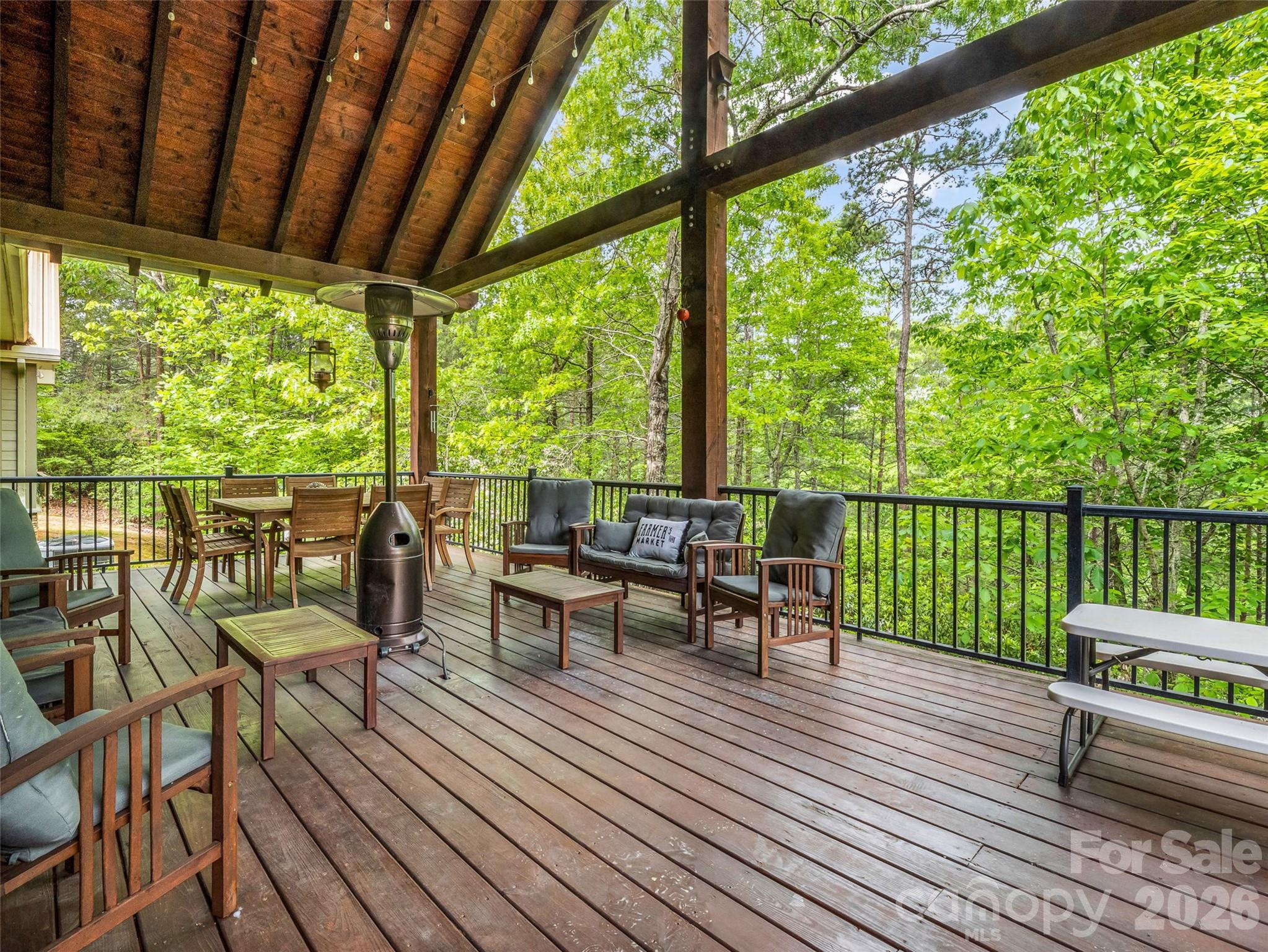 174 Rock Ridge Lake Lure, NC 28746 - Photo 37 of 48 a view of a balcony with chairs and wooden floor