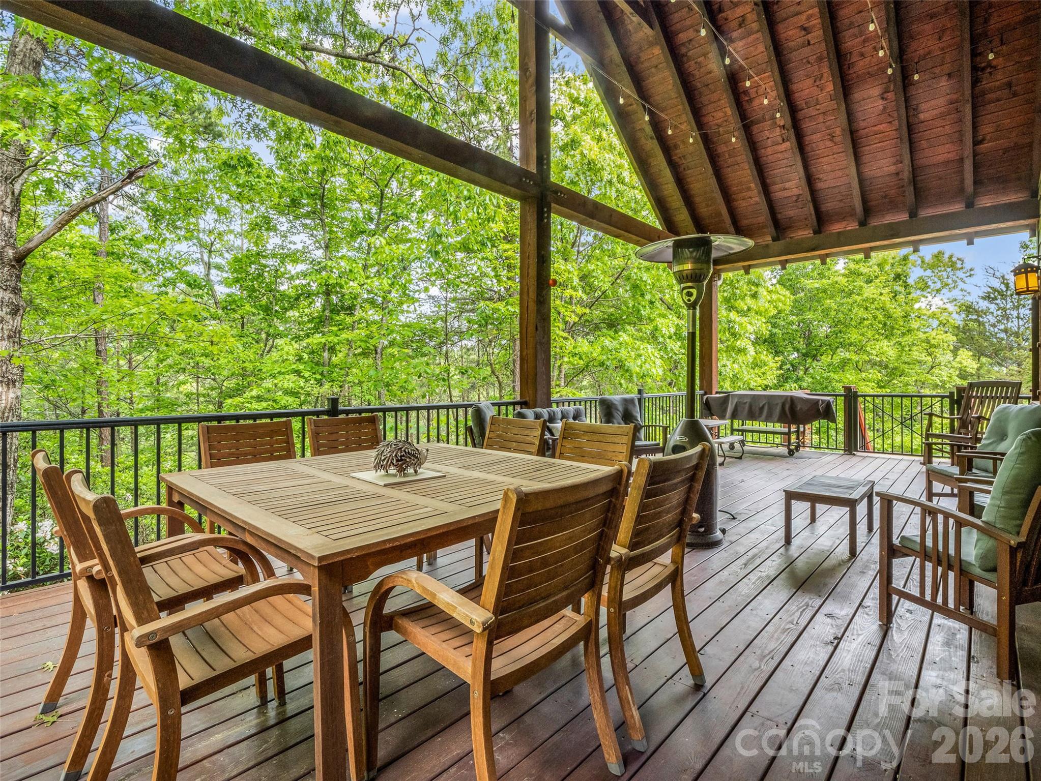 174 Rock Ridge Lake Lure, NC 28746 - Photo 38 of 48 a view of a patio with a table chairs and a table