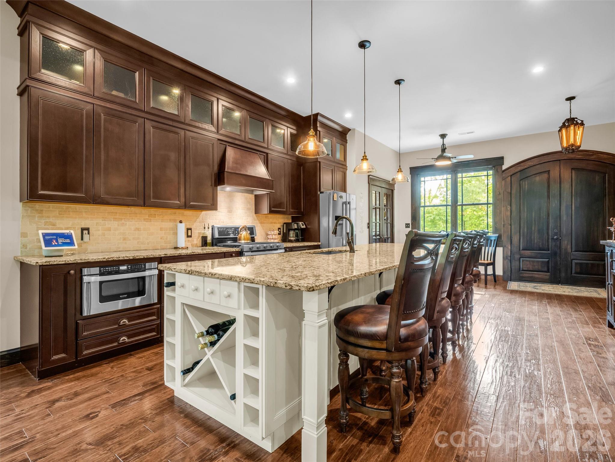 174 Rock Ridge Lake Lure, NC 28746 - Photo 8 of 48 a kitchen with stainless steel appliances kitchen island granite countertop a stove a sink and a refrigerator