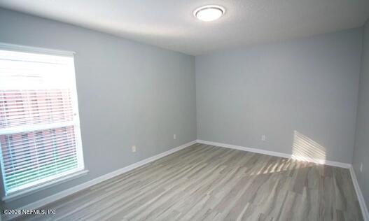 1113 Andrea Way St. Johns, FL 32259 - Photo 13 of 30 a view of an empty room with wooden floor and a window