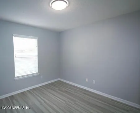 an empty room with closet and wooden floor