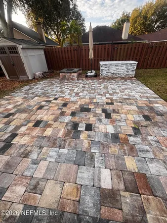 a backyard of a house with table and chairs
