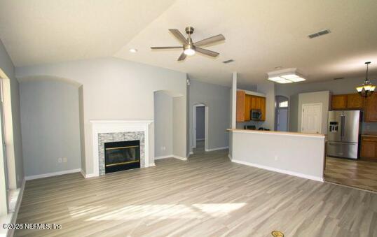 1113 Andrea Way St. Johns, FL 32259 - Photo 30 of 30 a view of a livingroom with a fireplace a ceiling fan and kitchen view