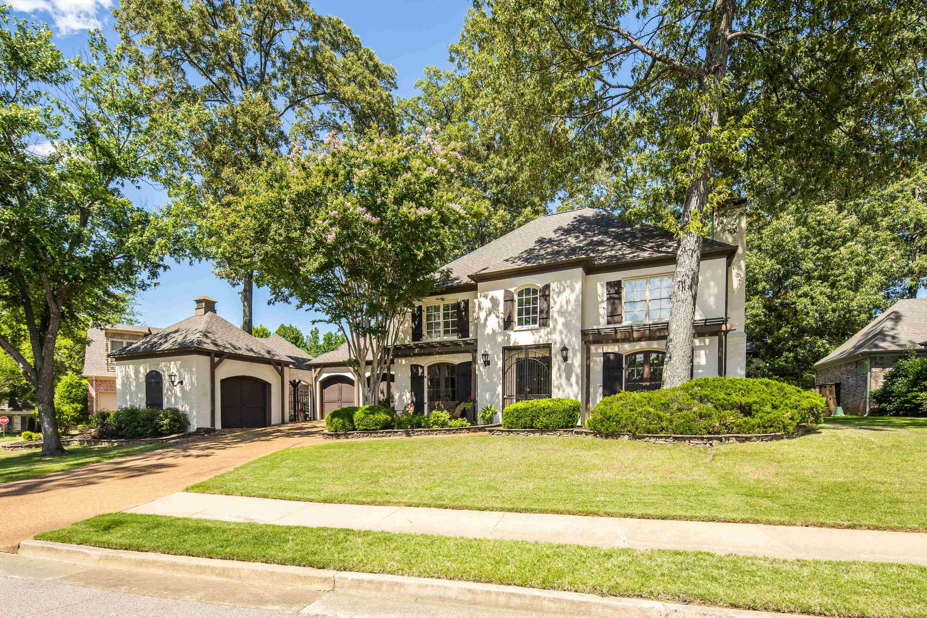 a front view of a house with a garden