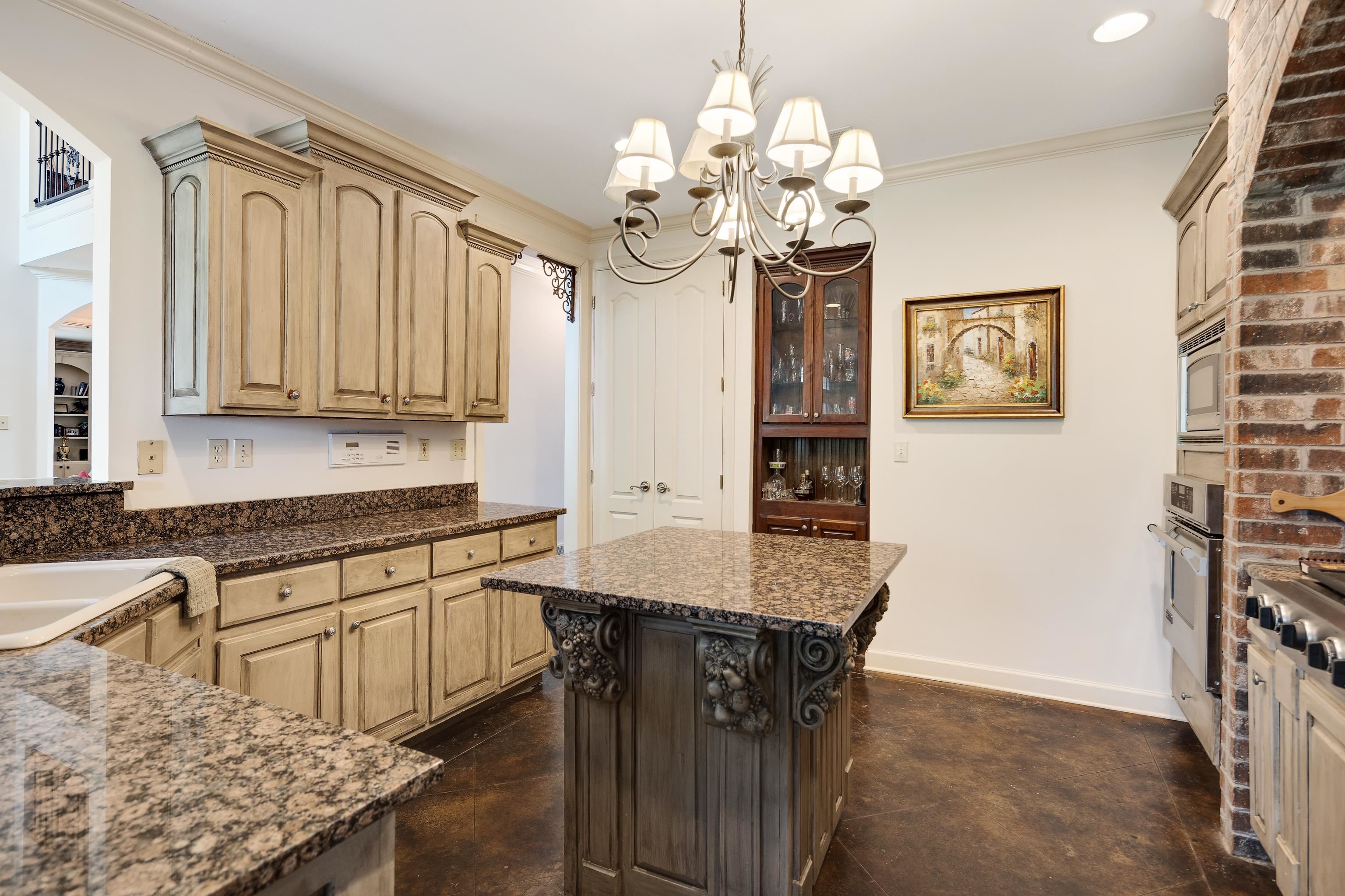 210 Ivy Grove Lane Collierville, TN 38017 - Photo 16 of 40 a kitchen with stainless steel appliances granite countertop a sink dishwasher a stove a dining table and chairs with wooden floor