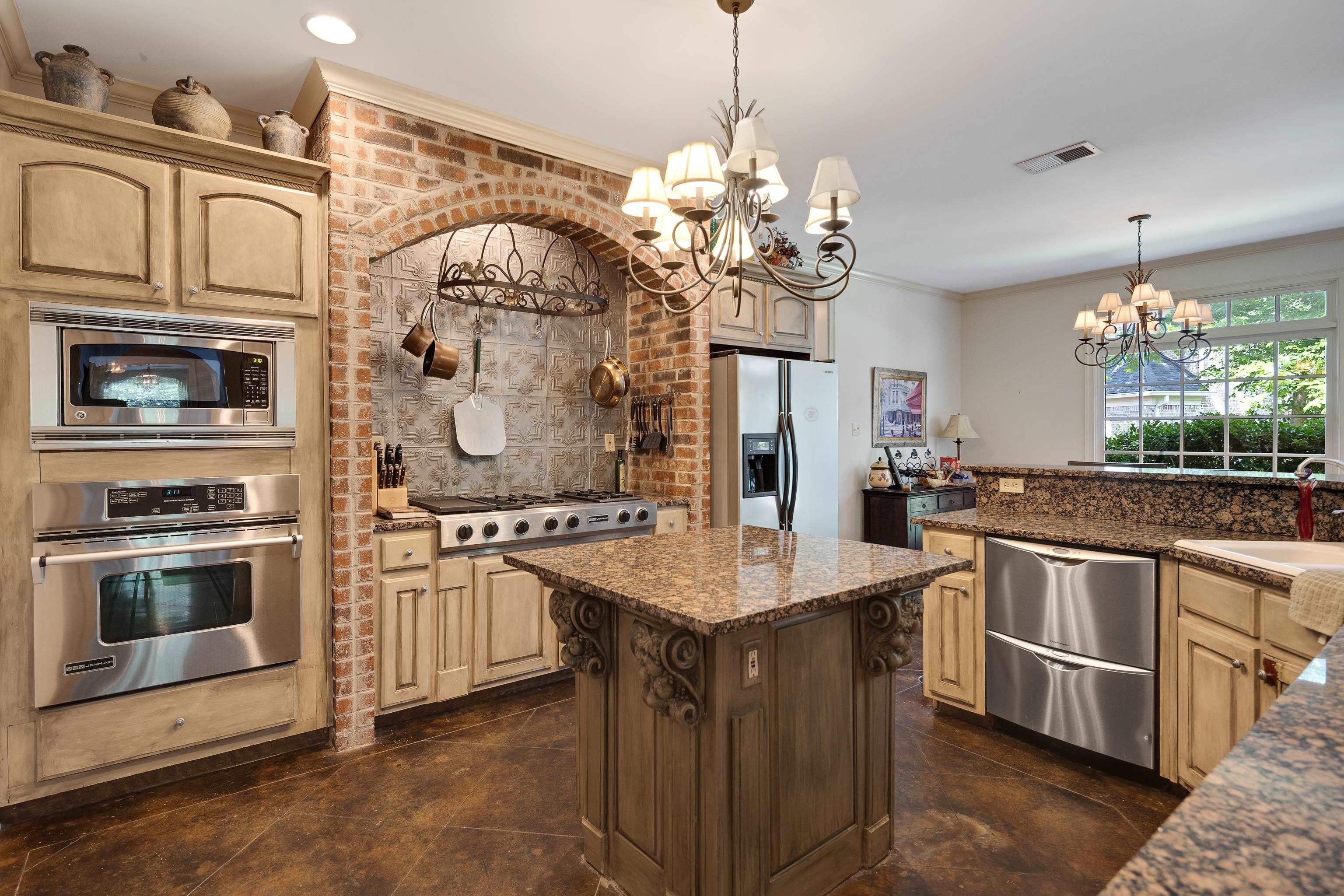 210 Ivy Grove Lane Collierville, TN 38017 - Photo 17 of 40 a kitchen with stainless steel appliances granite countertop a stove and a sink