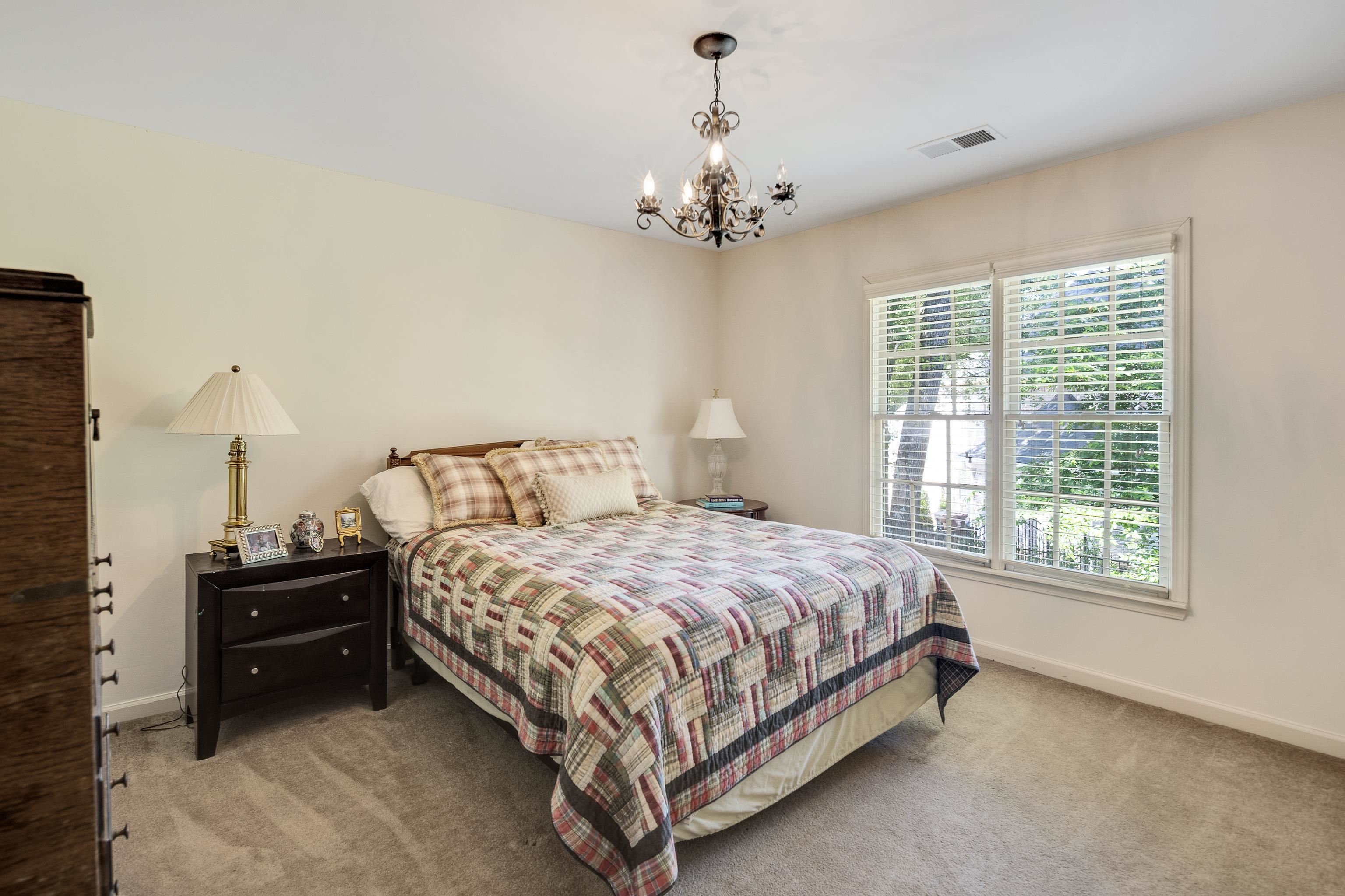 210 Ivy Grove Lane Collierville, TN 38017 - Photo 30 of 40 a bedroom with a bed chandelier and a window