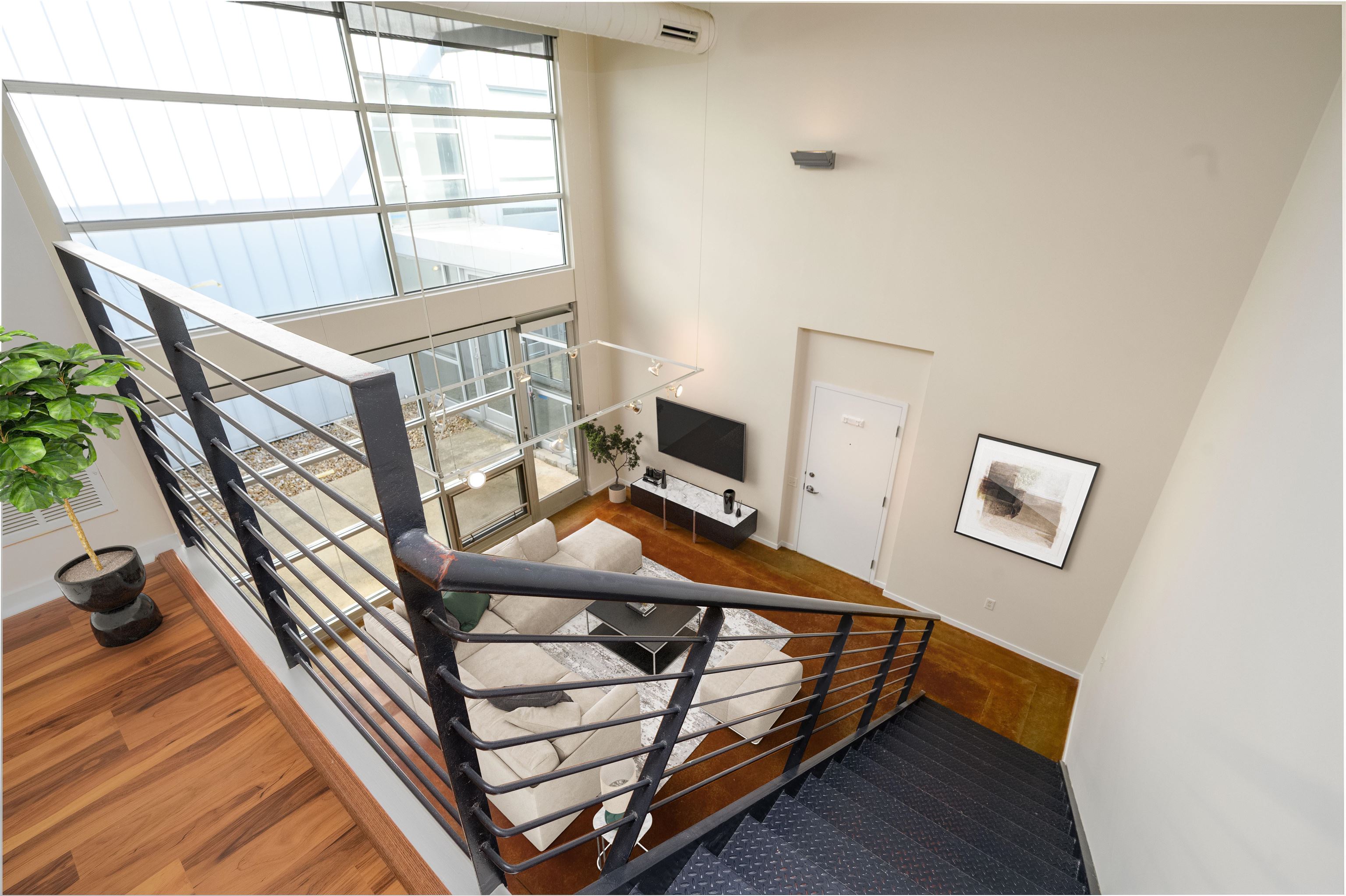 415 South Front Street, Unit 114 Memphis, TN 38103 - Photo 17 of 26 a bedroom with furniture and a window