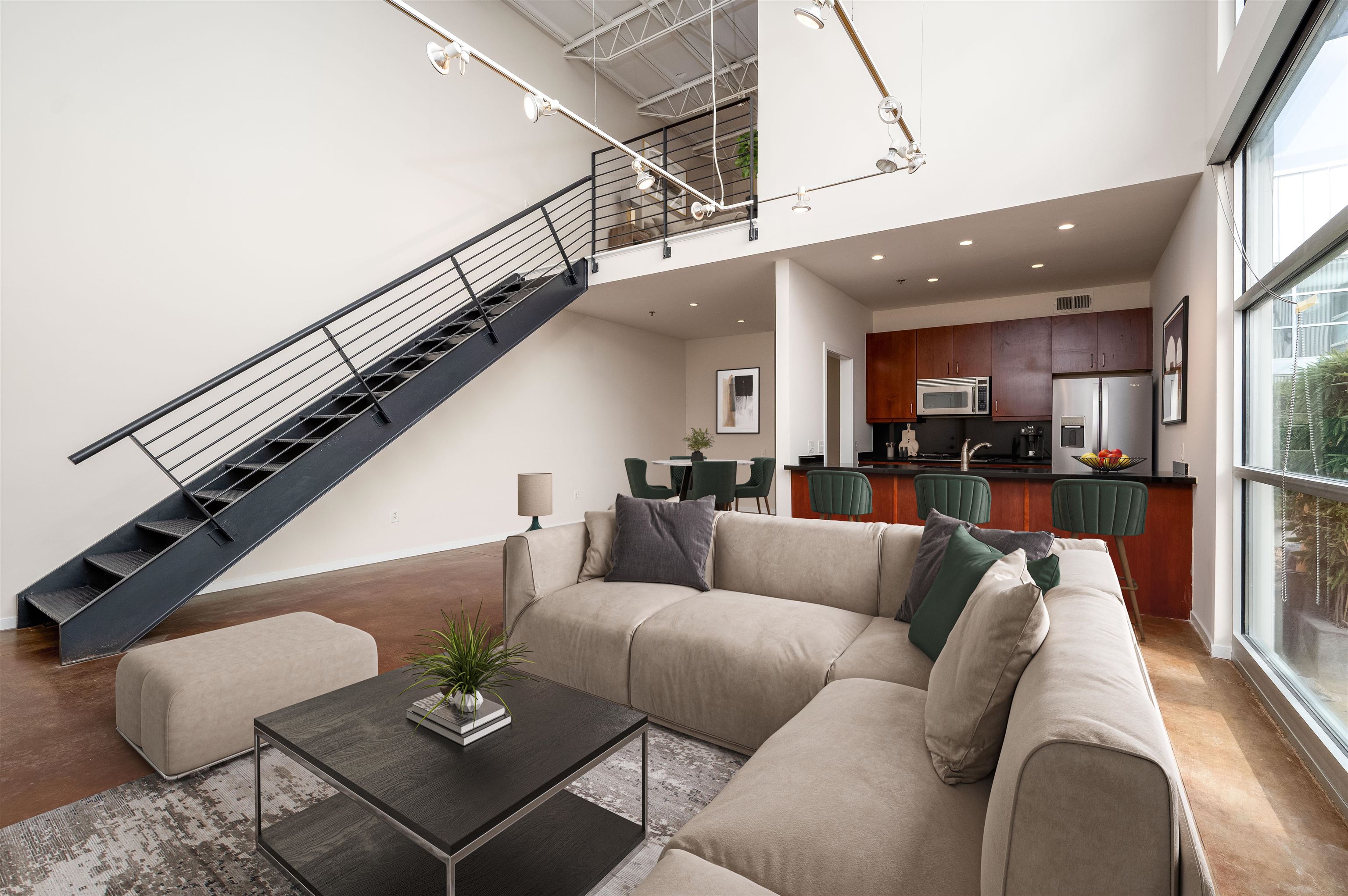 415 South Front Street, Unit 114 Memphis, TN 38103 - Photo 3 of 26 a living room with furniture kitchen view and a chandelier