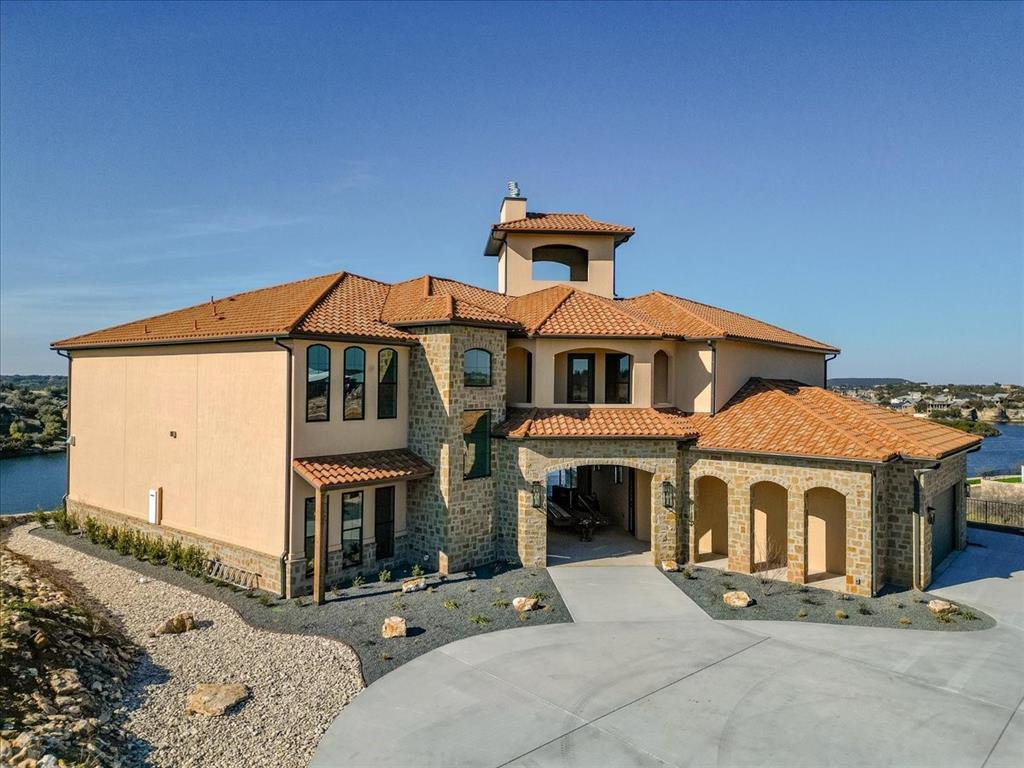 7085 West Hells Gate Drive Strawn, TX 76475 - Photo 1 of 40 a front view of a house with a yard