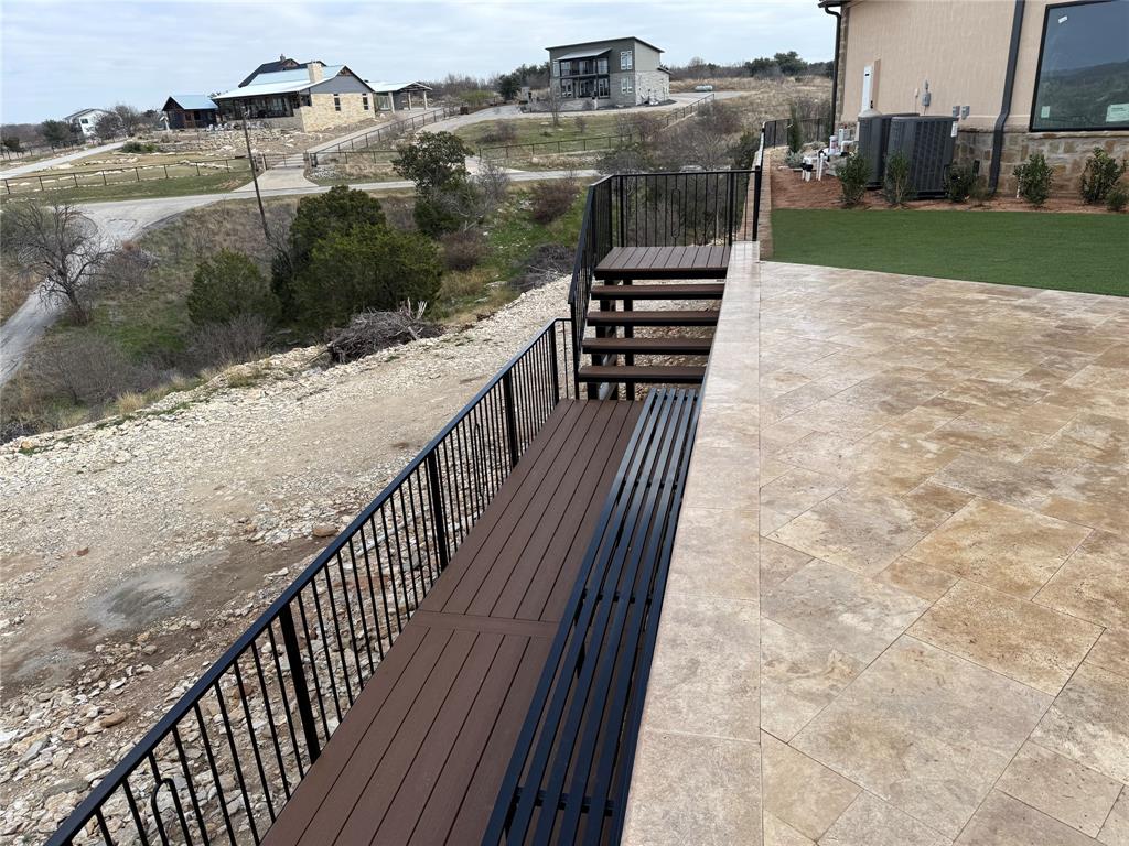 7085 West Hells Gate Drive Strawn, TX 76475 - Photo 12 of 40 a view of a balcony with wooden floor and lake view