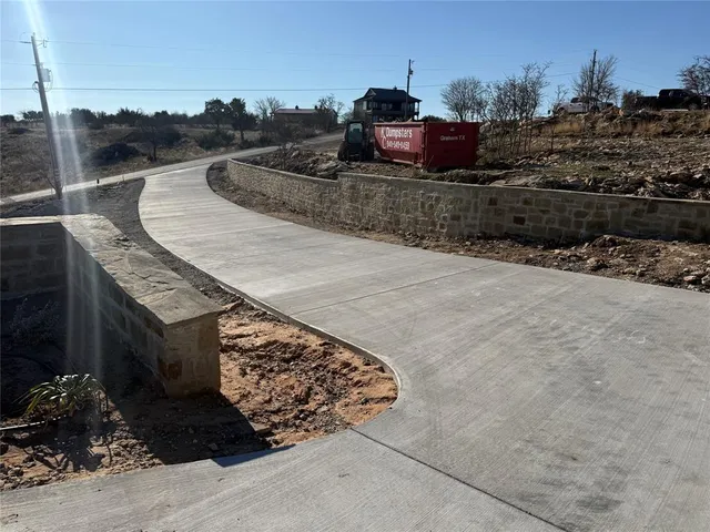 a large kitchen with stainless steel appliances granite countertop a lot of counter space and wooden floors