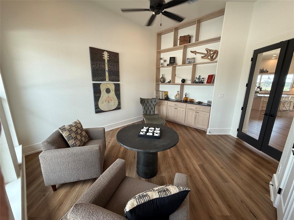 7085 West Hells Gate Drive Strawn, TX 76475 - Photo 27 of 40 a living room with furniture and a wooden floor