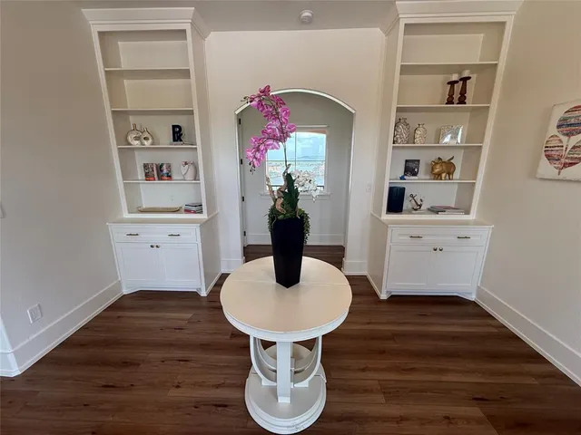 a kitchen with appliances cabinets and a wooden floor
