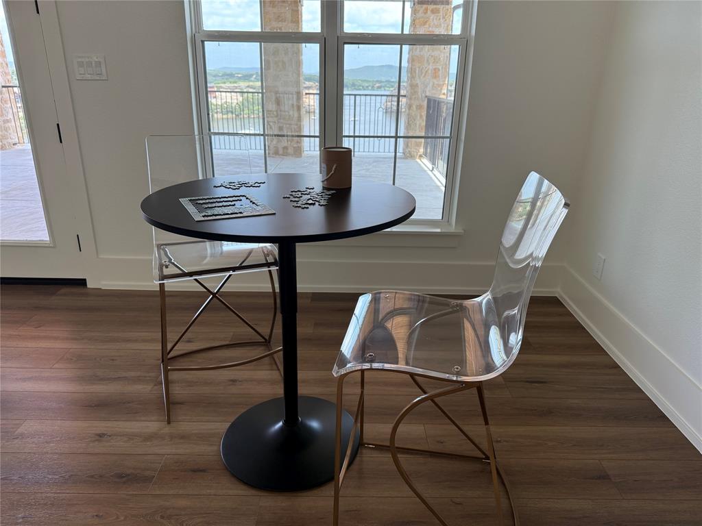 7085 West Hells Gate Drive Strawn, TX 76475 - Photo 34 of 40 a dining room with furniture and wooden floor