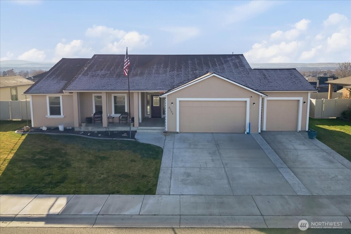 6304 Turf Paradise Drive Pasco, WA 99301 - Photo 1 of 40 a front view of a house with a yard