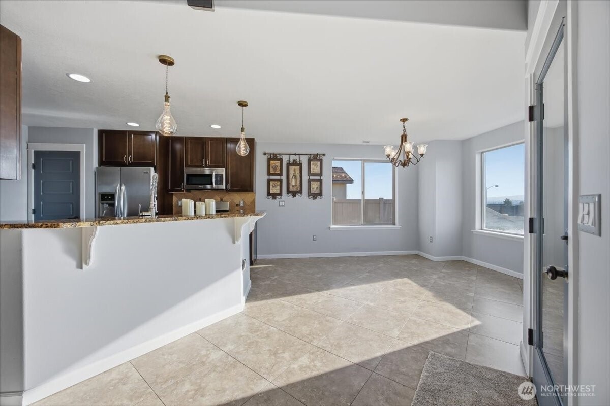 6304 Turf Paradise Drive Pasco, WA 99301 - Photo 20 of 40 a view of kitchen with refrigerator and window