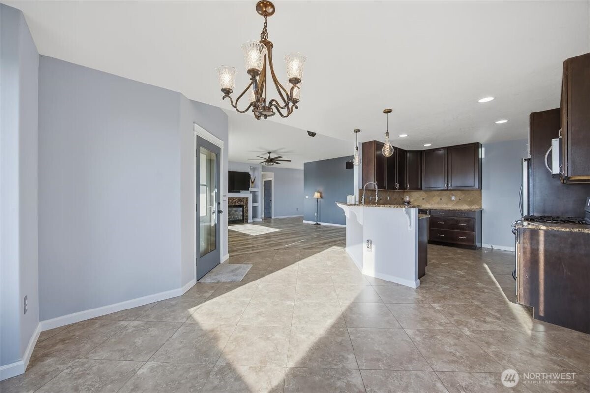 6304 Turf Paradise Drive Pasco, WA 99301 - Photo 22 of 40 a view of a kitchen with a sink stainless steel appliances and cabinets
