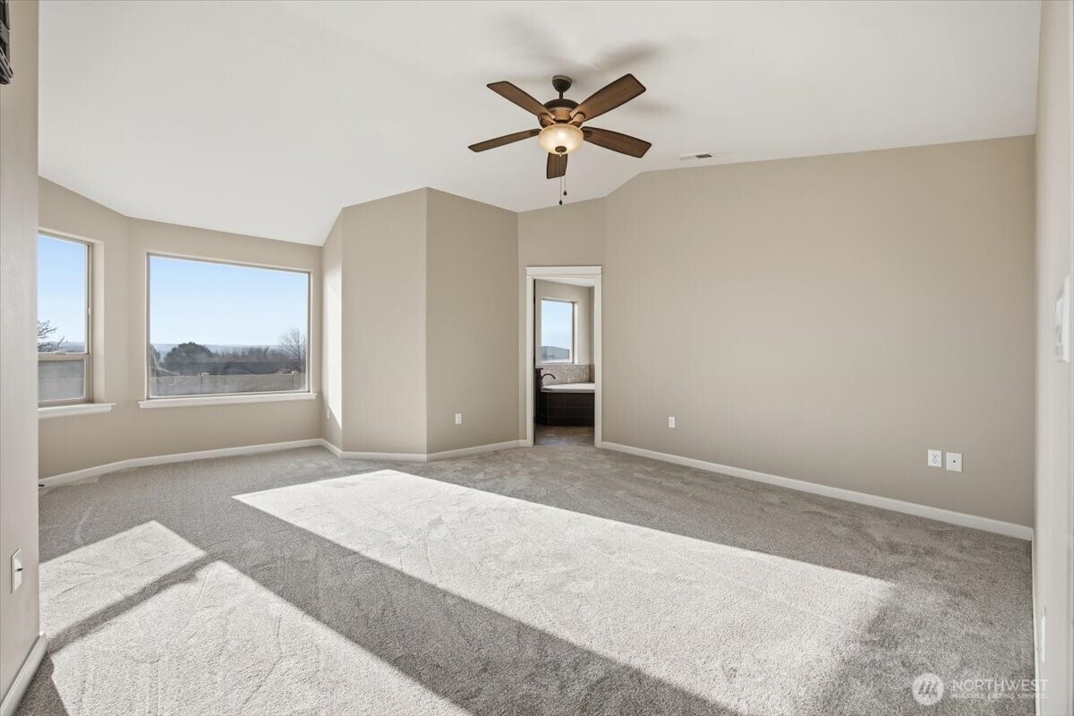 6304 Turf Paradise Drive Pasco, WA 99301 - Photo 7 of 40 a view of a livingroom with a ceiling fan and window