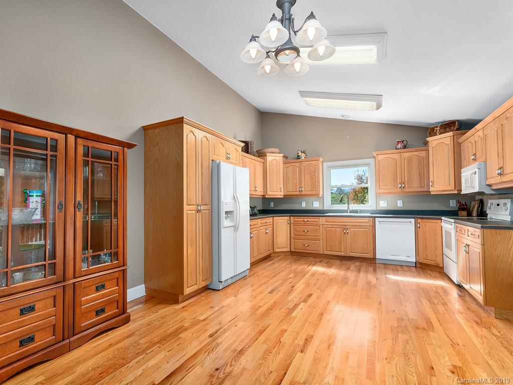 23 Yarrow Road Waynesville, NC 28785 - Photo 8 of 24 a large kitchen with stainless steel appliances a large counter top and wooden floors