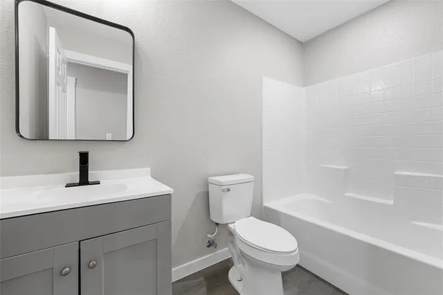 a white toilet sitting next to a bathroom sink