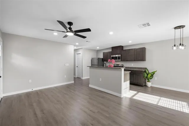a kitchen with a refrigerator and a microwave