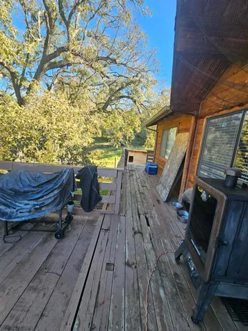a view of balcony with wooden floor and outdoor seating