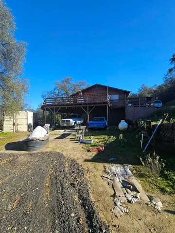 a view of a house with backyard and sitting area