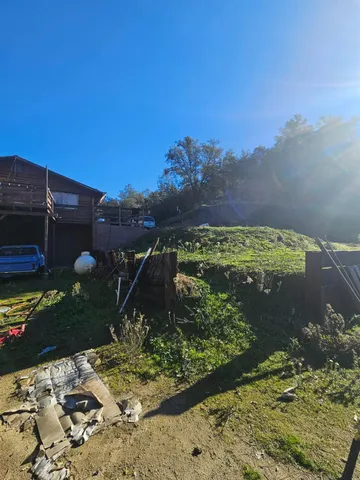 a view of a field with trees in the background